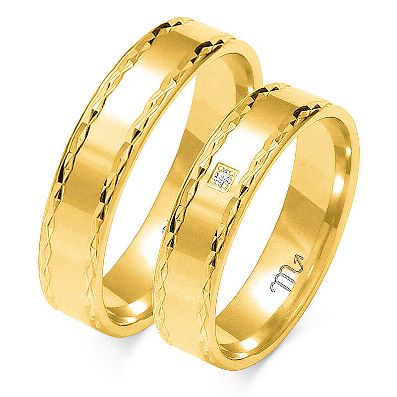 Anéis de casamento brilhantes gravados com uma pedra