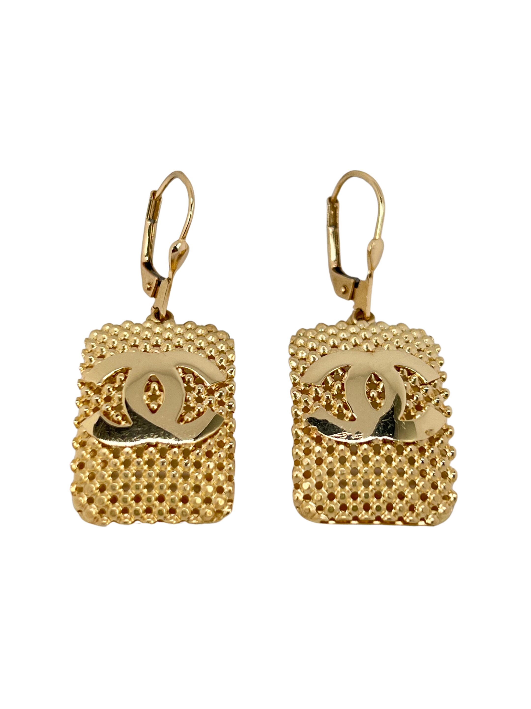 Gold earrings with the letters CC