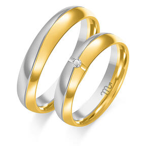 Shiny wedding bands with waves and stones